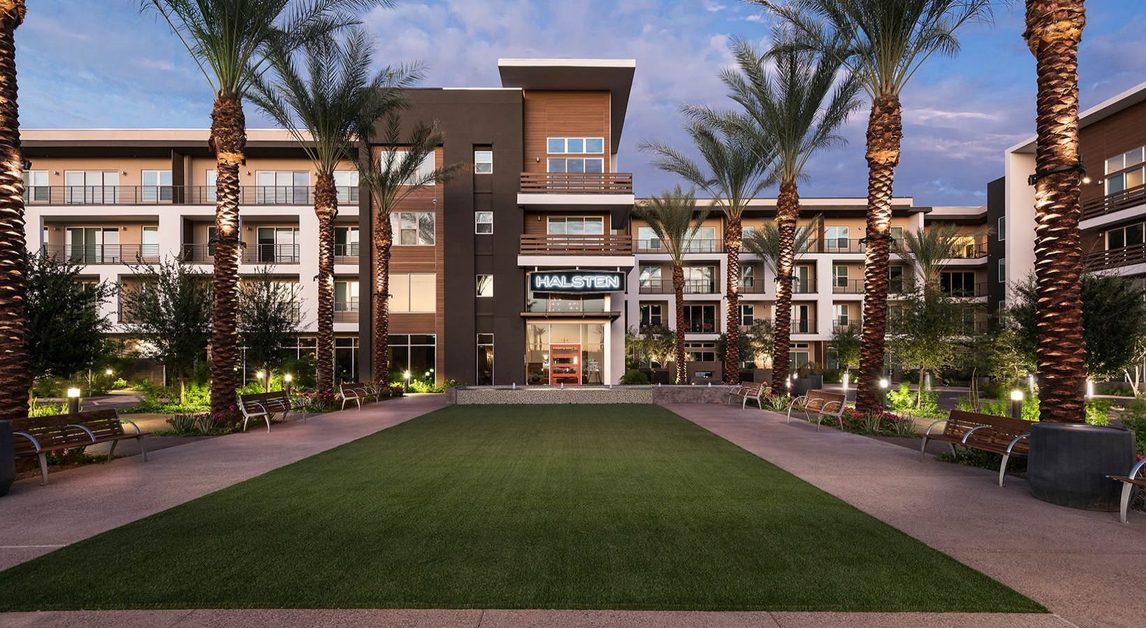 A large building with palm trees in front of it
