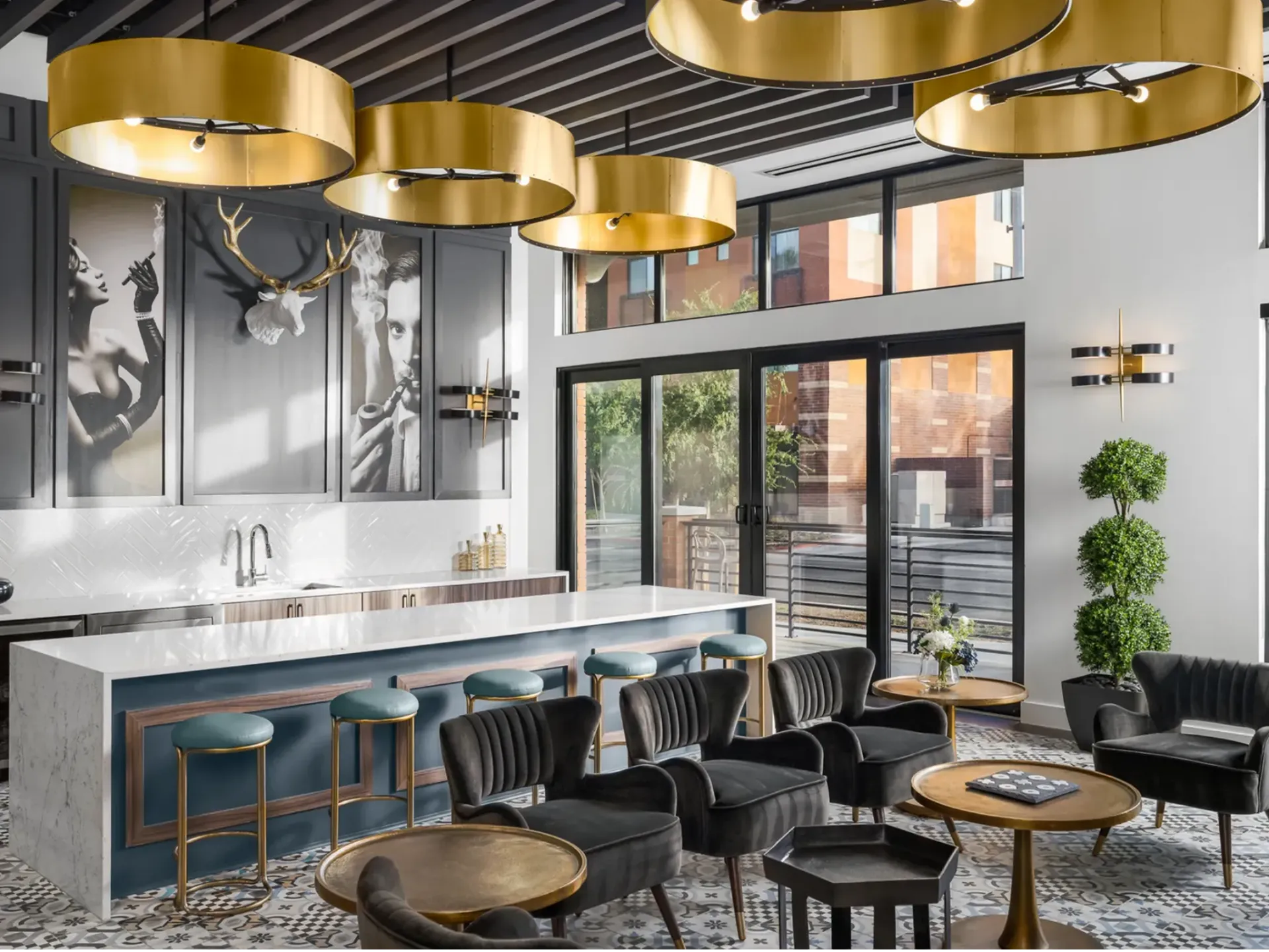 A living room with tables, chairs, a kitchen and a bar.