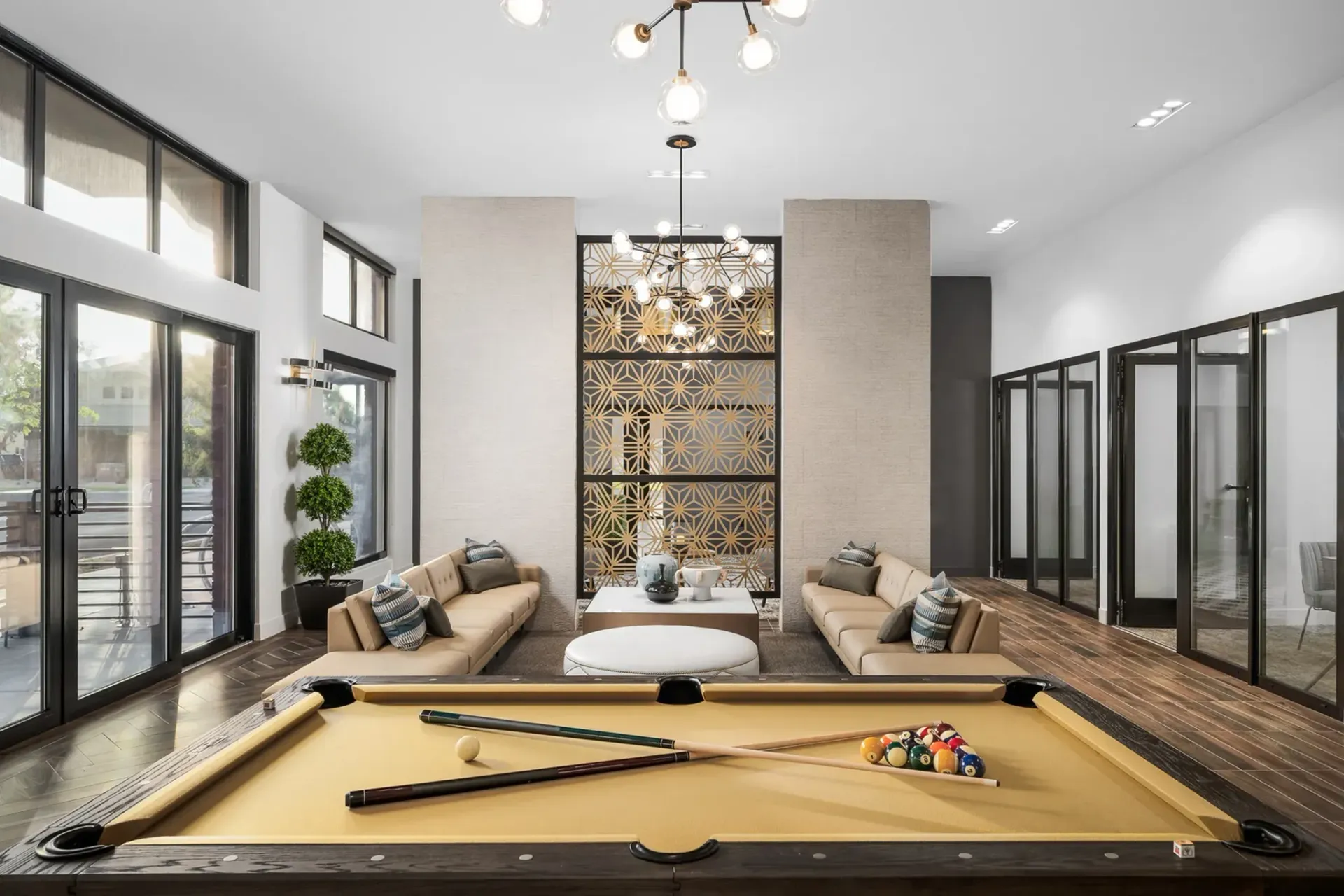 A pool table in the middle of a living room.