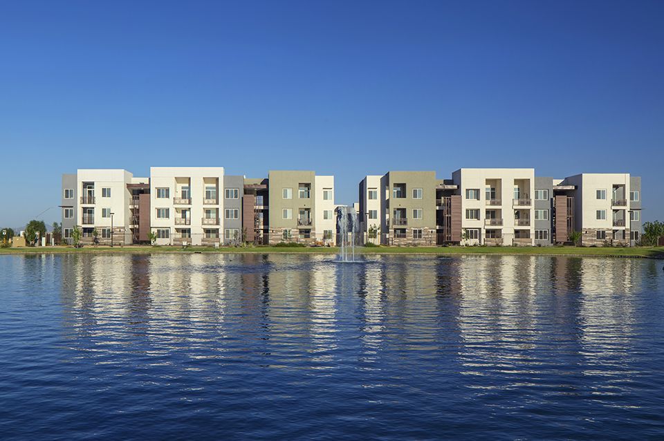 A row of apartment buildings next to a body of water