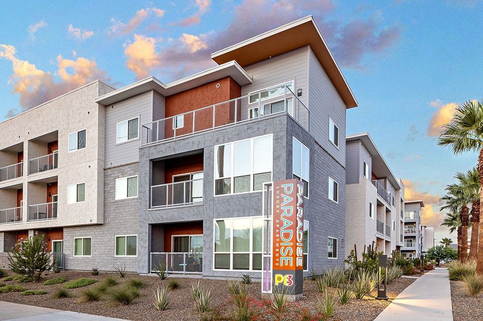 A large apartment building with a sign that says paradise on it