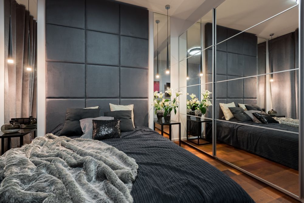 A Bedroom With a Bed , Mirrors and a Large Wardrobe — Glass 24/7 In Taree, NSW