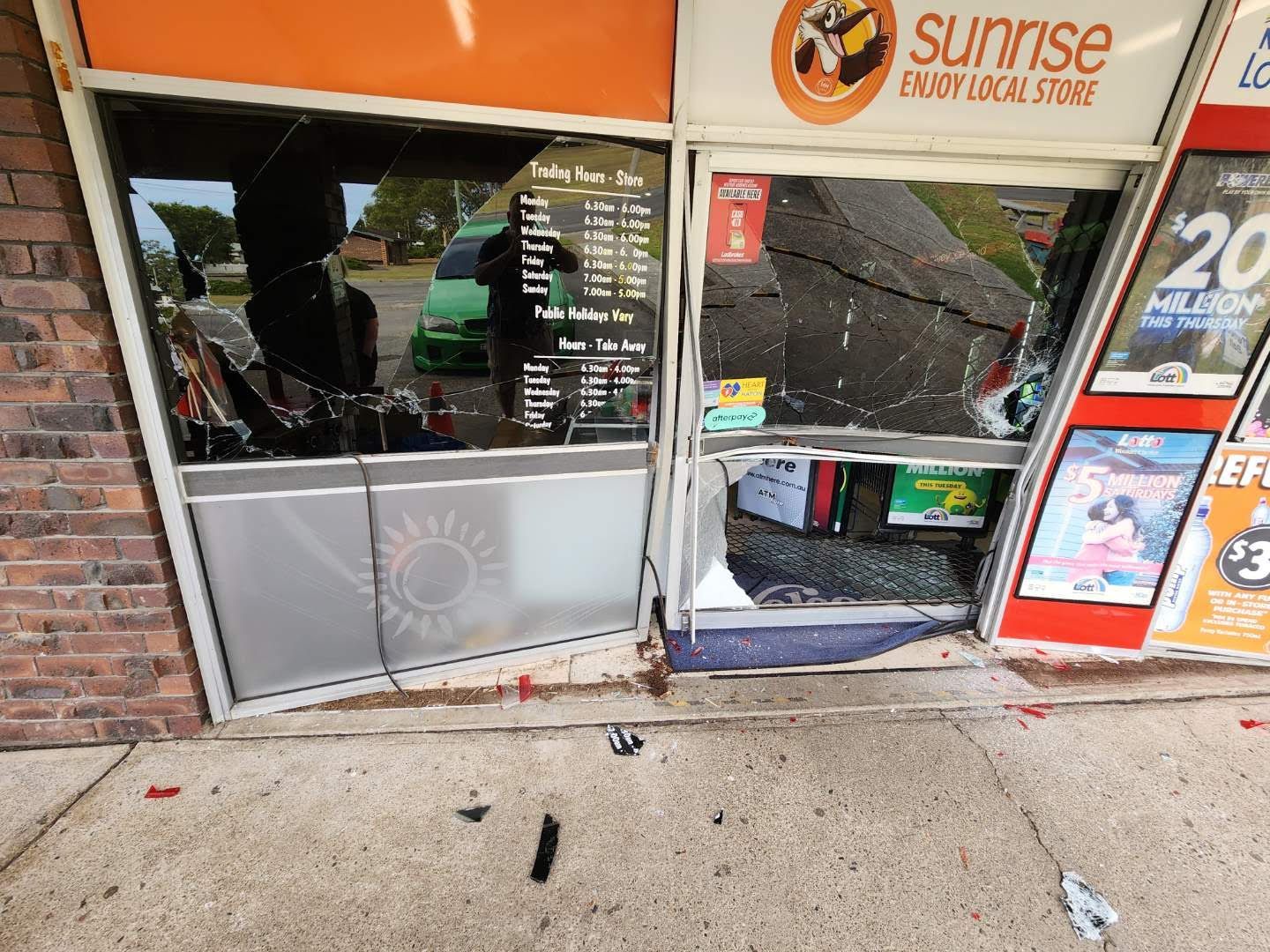 A store front with a broken window and a sign that says sunrise — Glass 24/7 In Taree, NSW