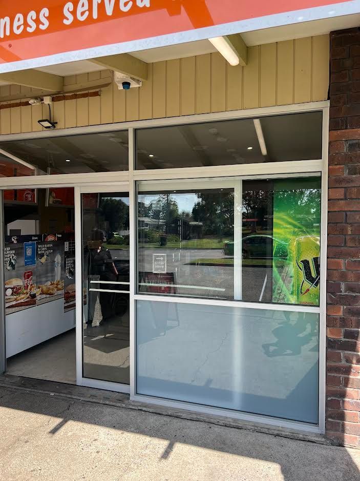 A Store Front With A Sliding Glass Door And A Sign That Says Ness Served — Glass 24/7 In Forster, NSW