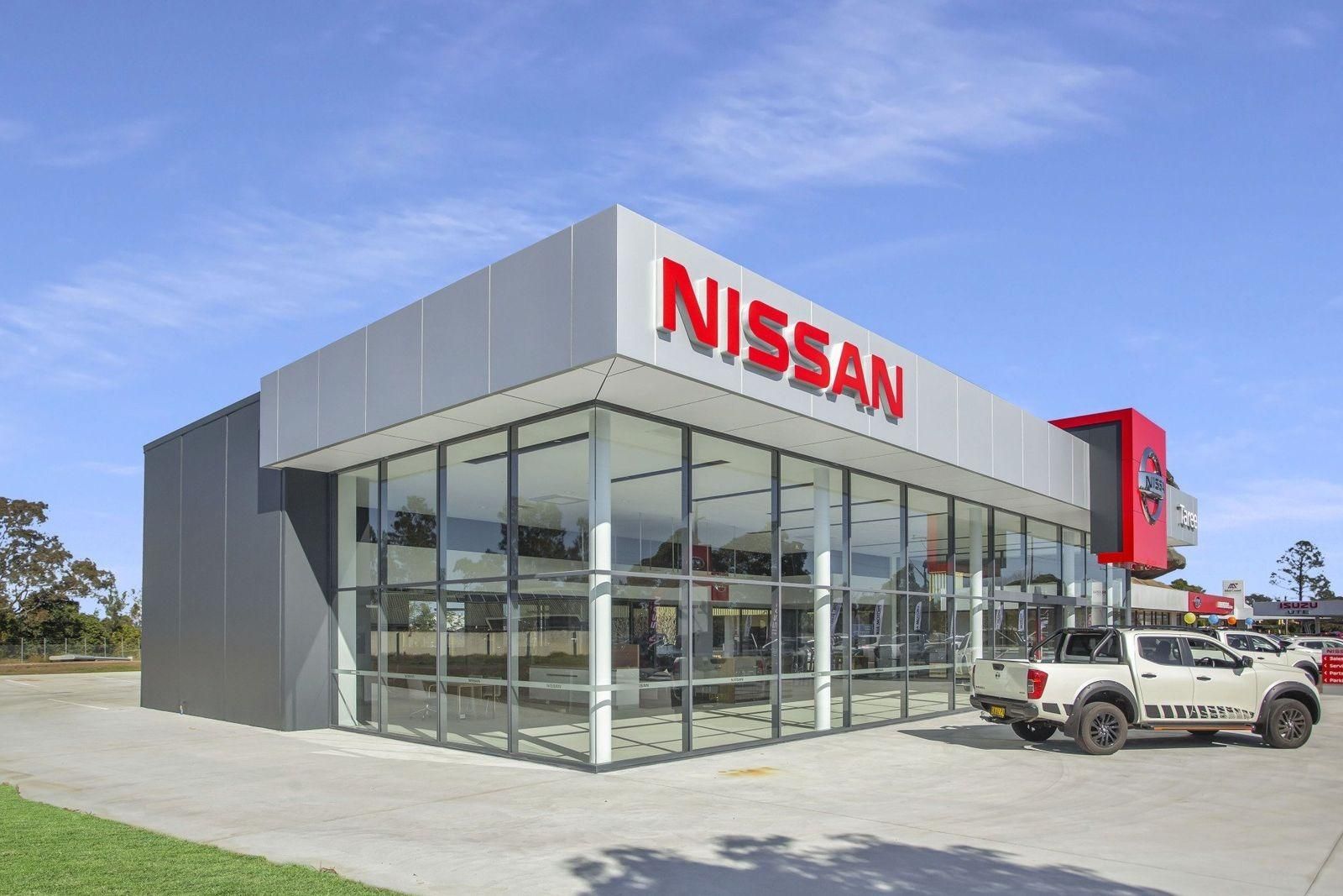 A Nissan Car Dealership With A White Truck Parked In Front Of It — Glass 24/7 In Forster, NSW
