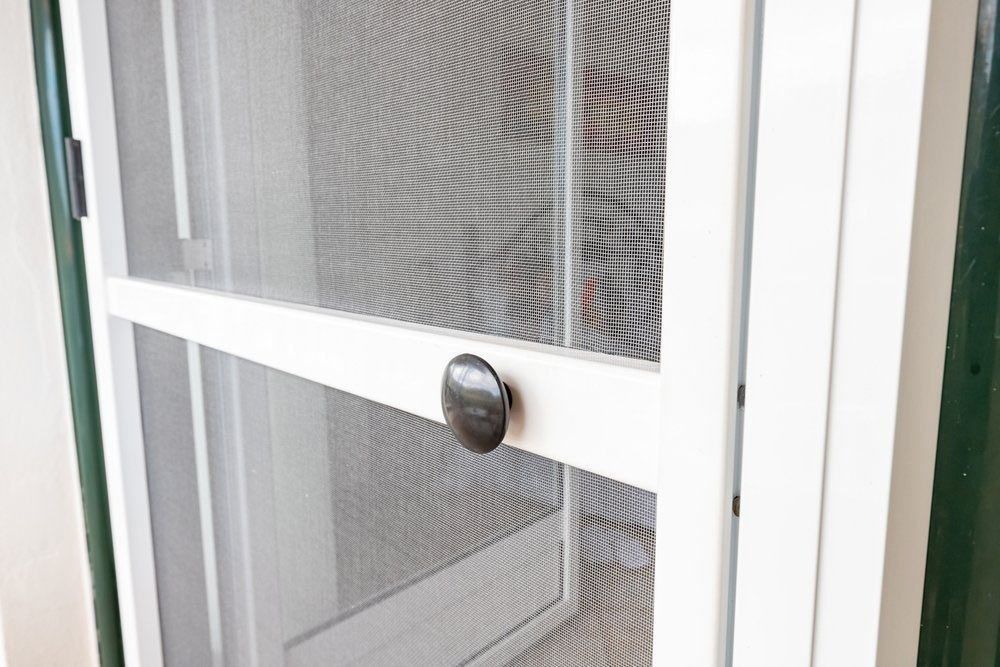 A Close Up Of A White Screen Door With A Black Handle — Glass 24/7 In Gloucester, NSW