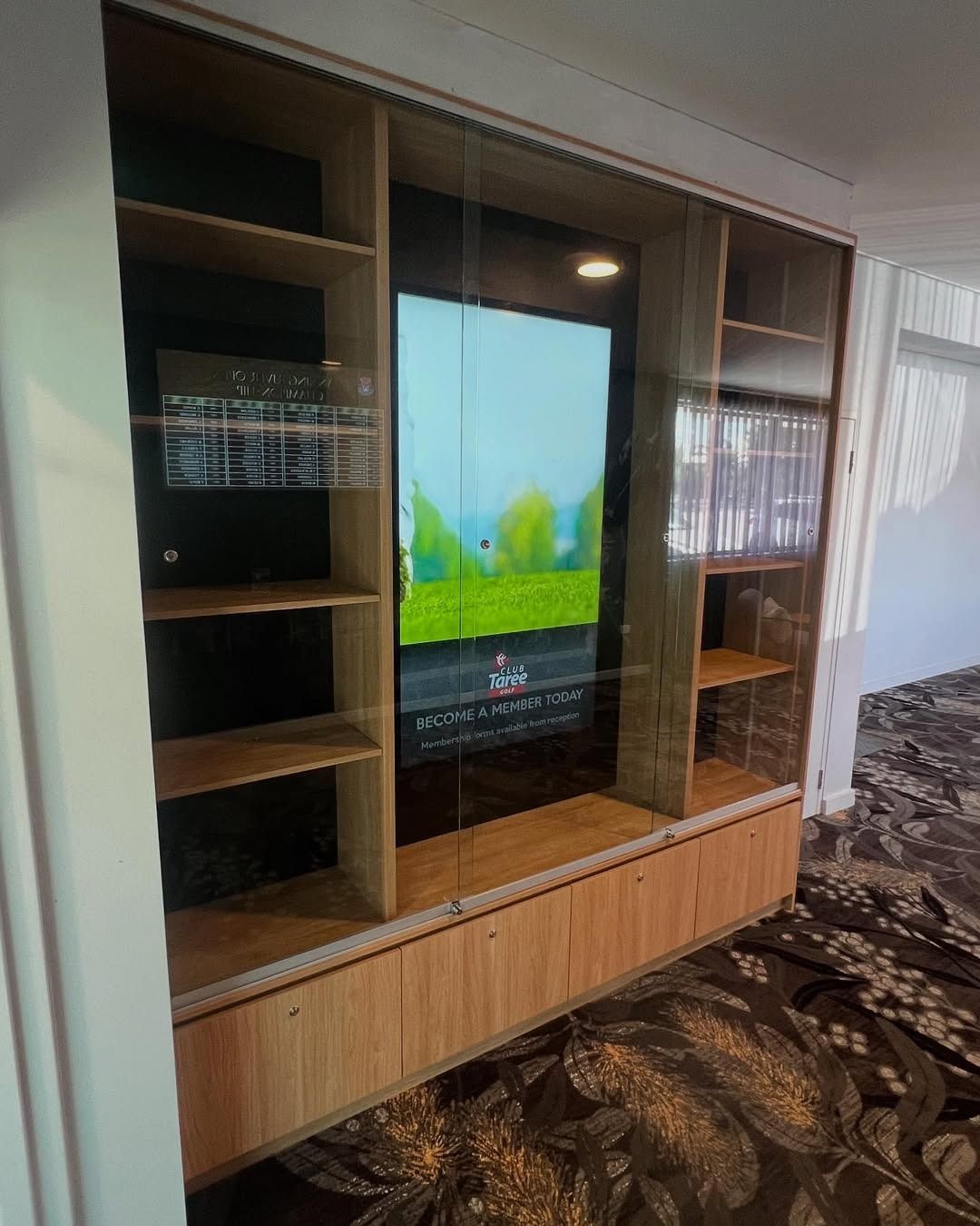 A Large Flat Screen Tv Is Sitting On Top Of A Wooden Entertainment Center — Glass 24/7 In Gloucester, NSW