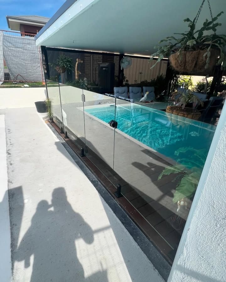 A Swimming Pool Is Surrounded By A Glass Fence — Glass 24/7 In Gloucester, NSW