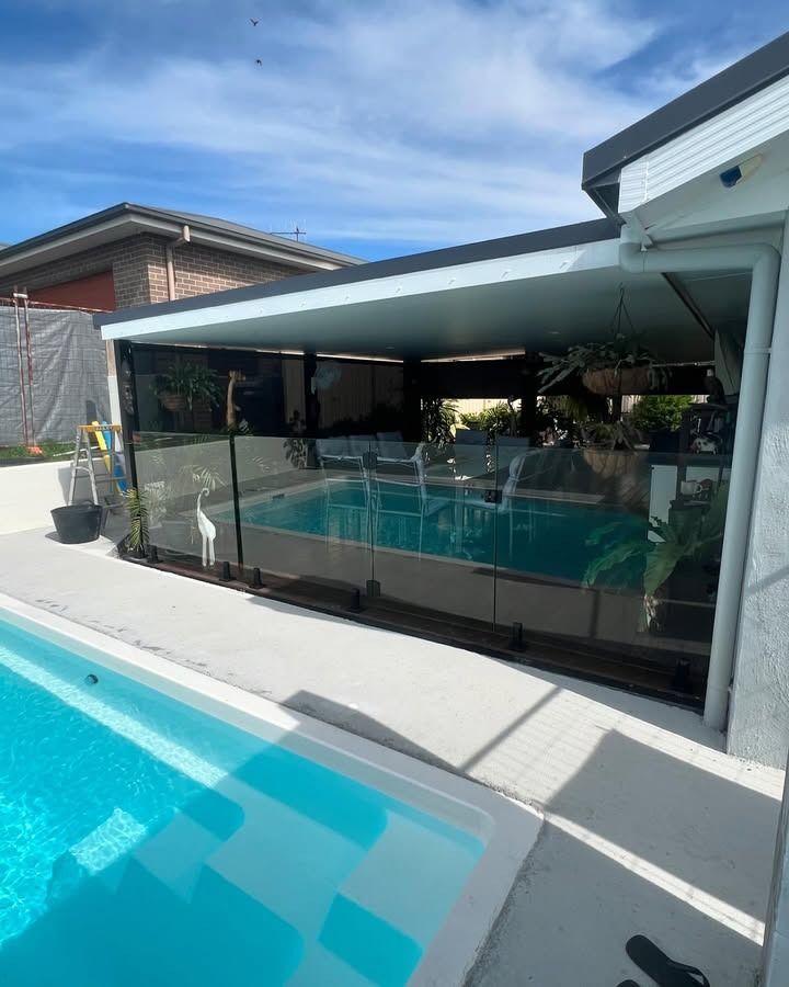 There Is A Swimming Pool In The Backyard Of A House — Glass 24/7 In Old Bar, NSW