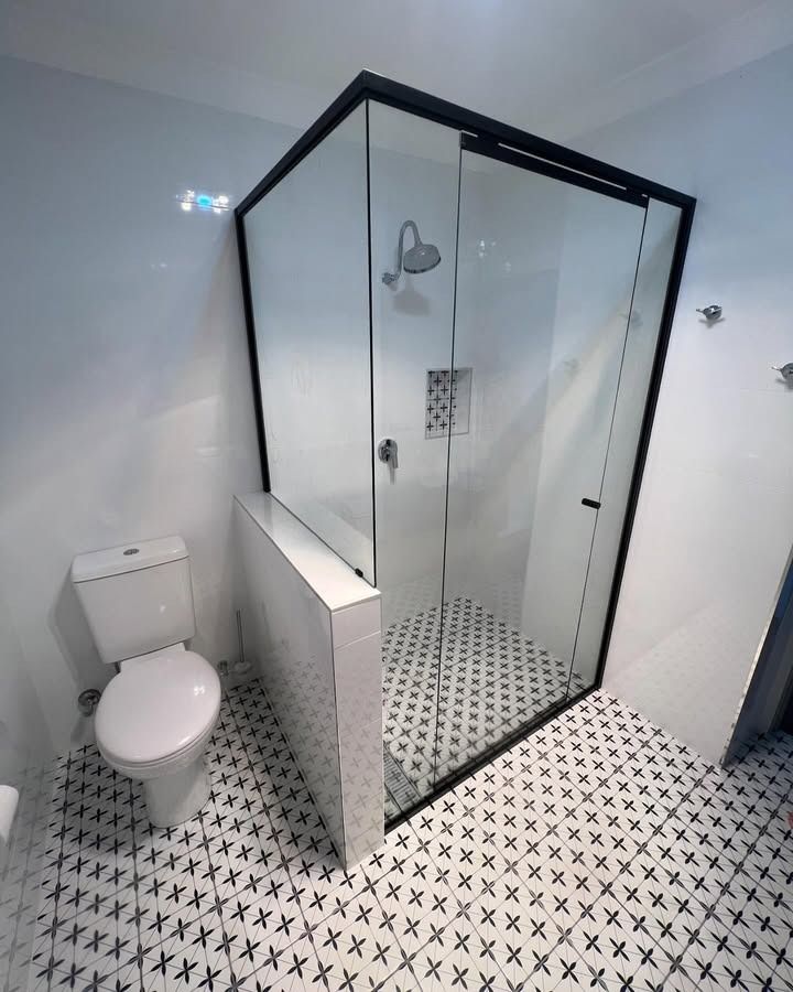 A Bathroom With A Toilet, Shower And Black And White Tiles — Glass 24/7 In Hallidays Point, NSW