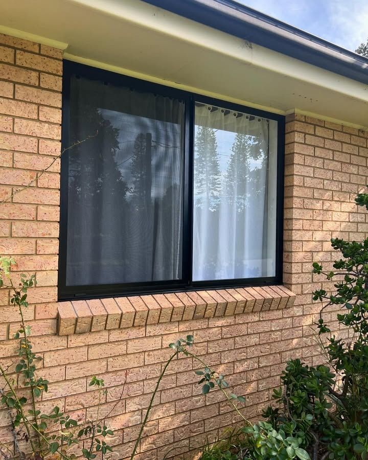 A Large Window On The Side Of A Brick House — Glass 24/7 In Harrington, NSW