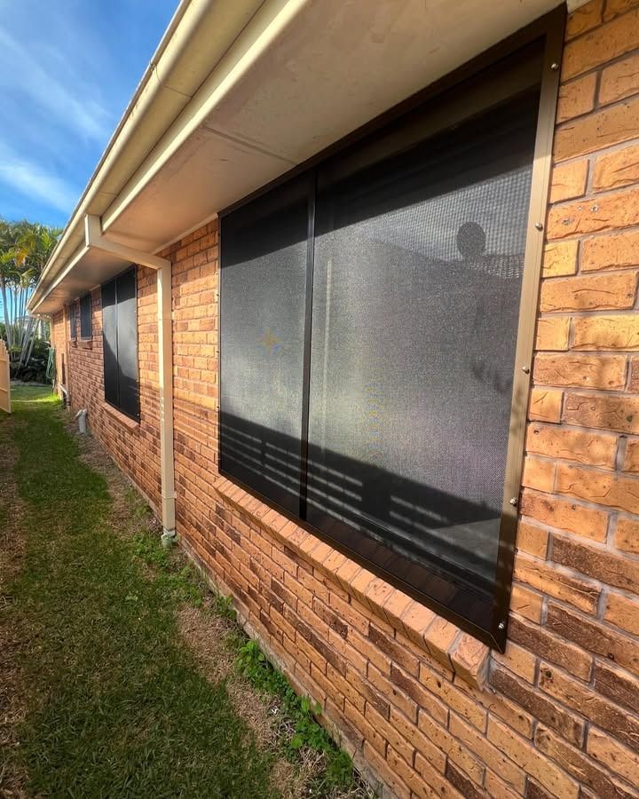 A Brick Building With A Black Screen On The Windows — Glass 24/7 In Harrington, NSW