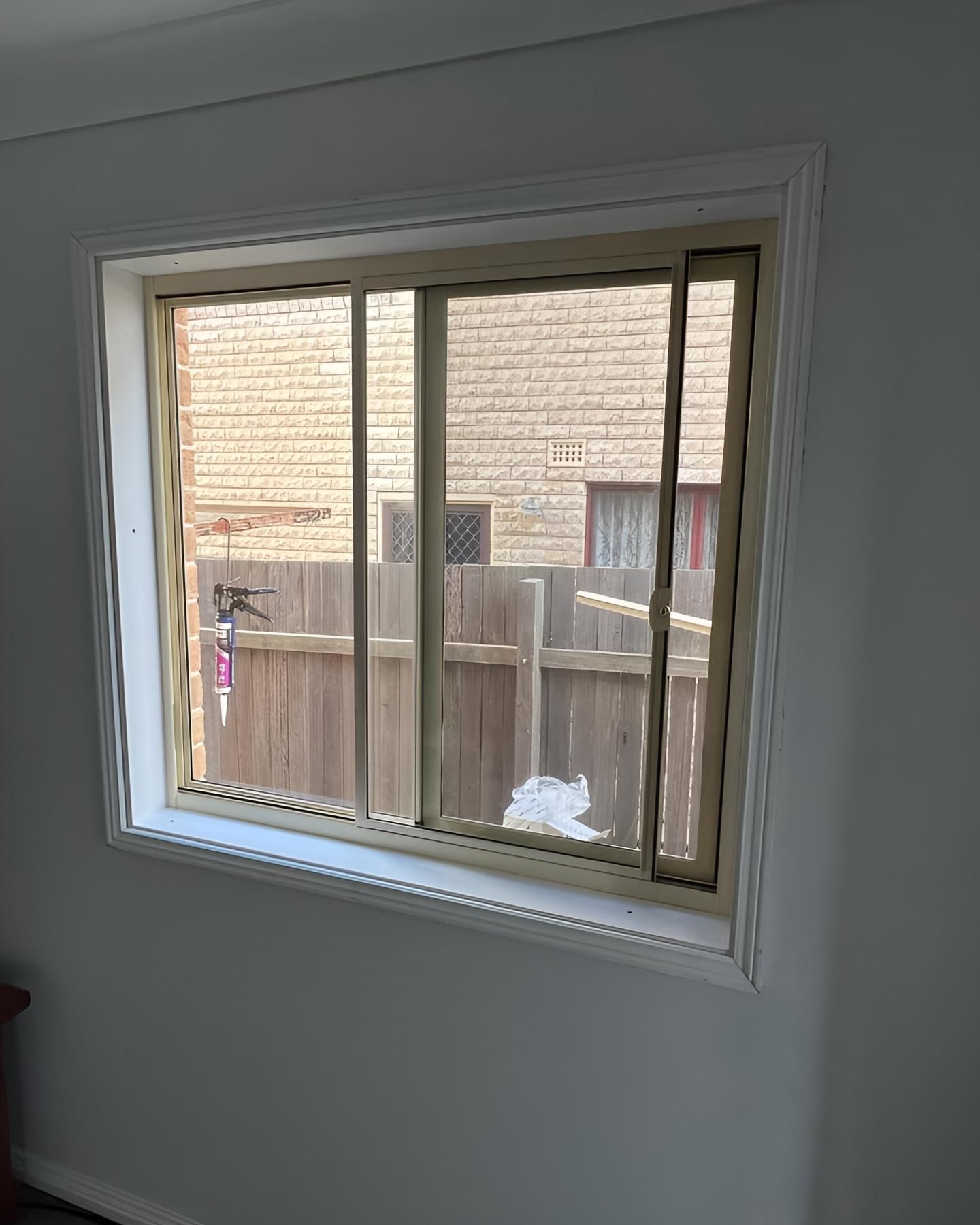 A Large Window In A Room With A Wooden Fence In The Background — Glass 24/7 In Tuncurry, NSW