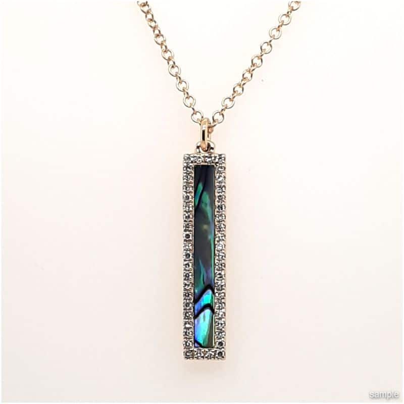 Gold necklace with rectangular abalone pendant framed by small clear stones.