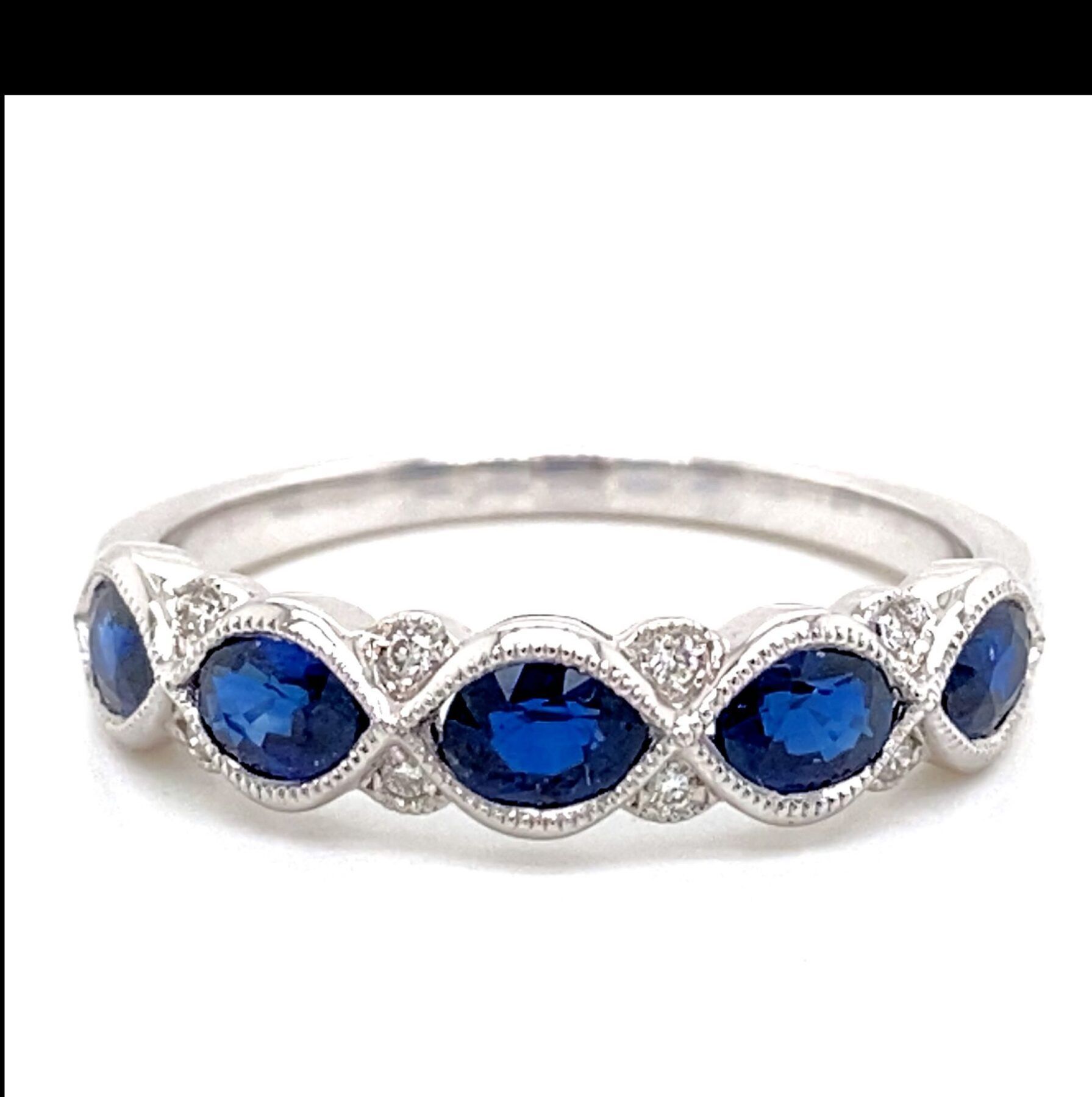 Silver ring with blue oval stones and small diamonds.