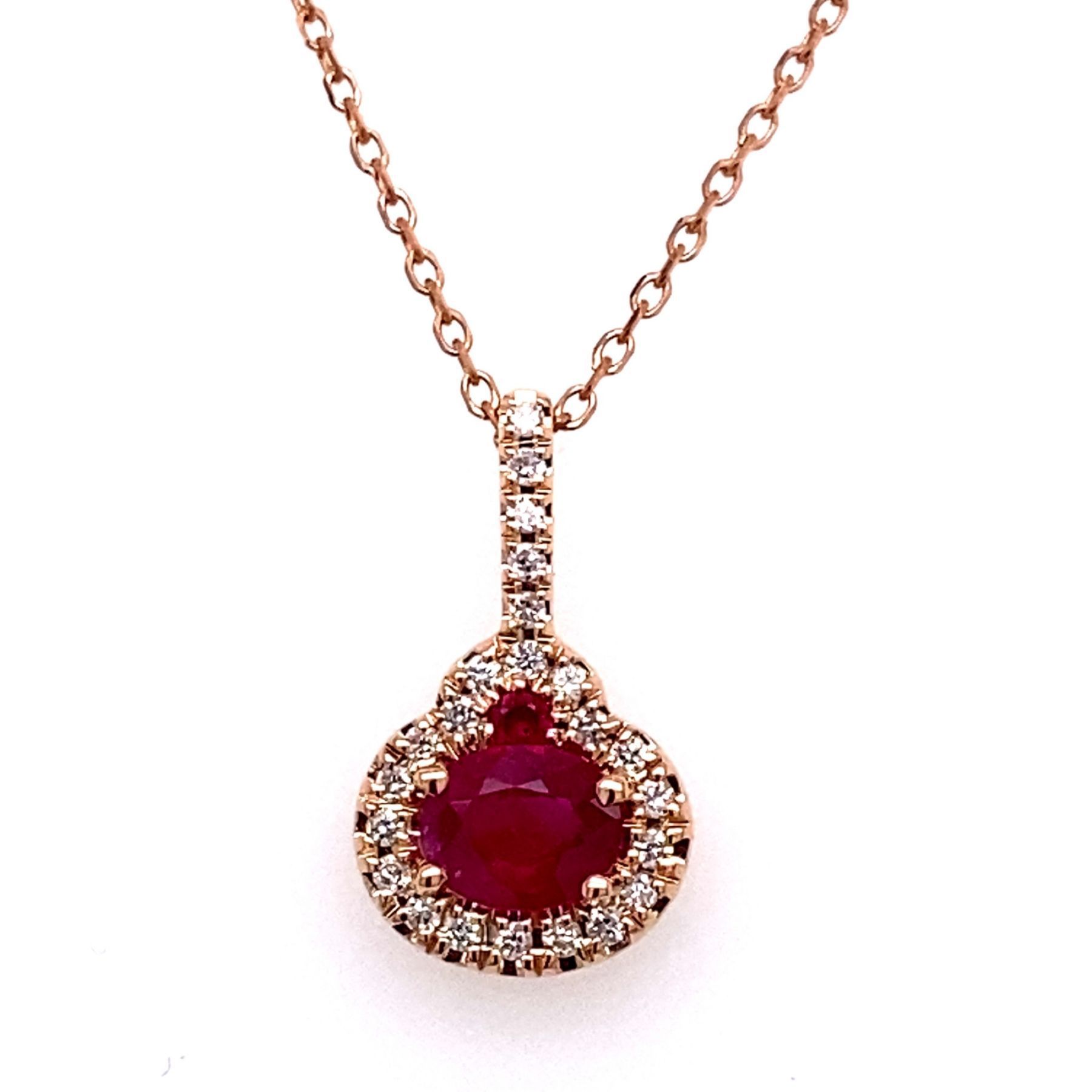 Rose gold necklace with a ruby pendant surrounded by diamonds.