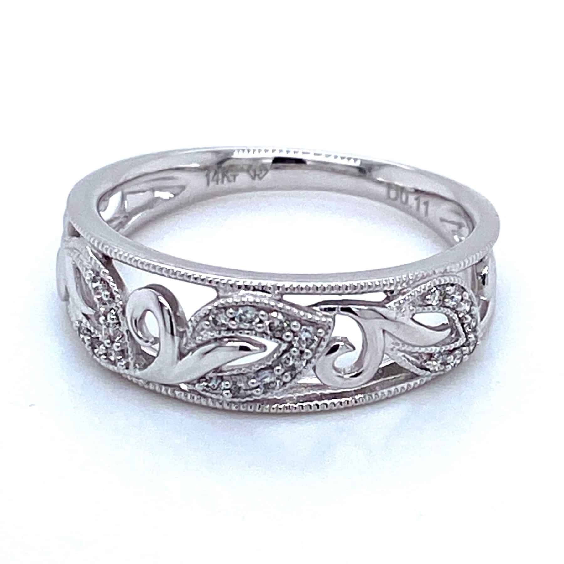 Silver ring with openwork floral design and small diamonds.