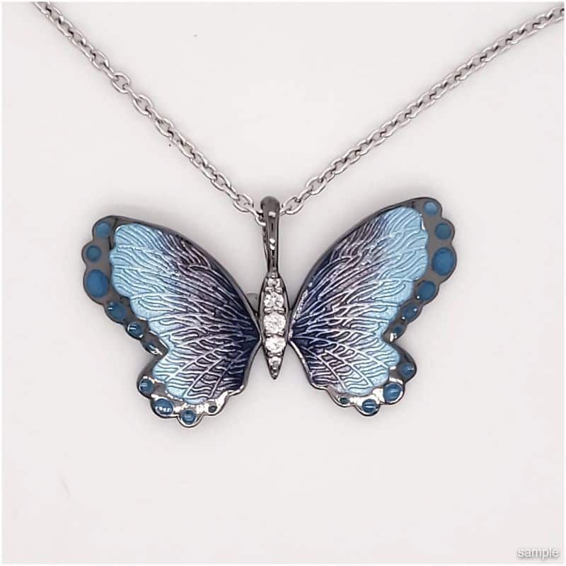 Silver butterfly pendant necklace with blue enamel wings and diamond accents.