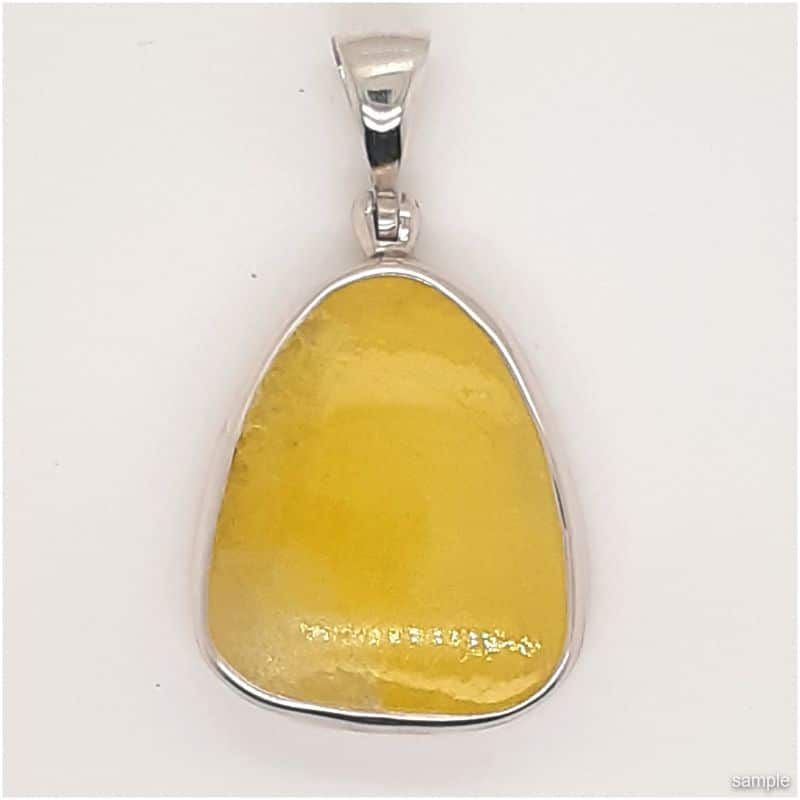 Yellow amber pendant with silver setting.