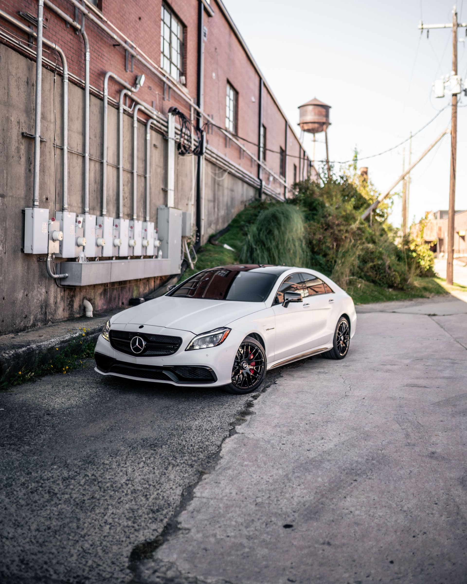 A white car is parked in front of a building