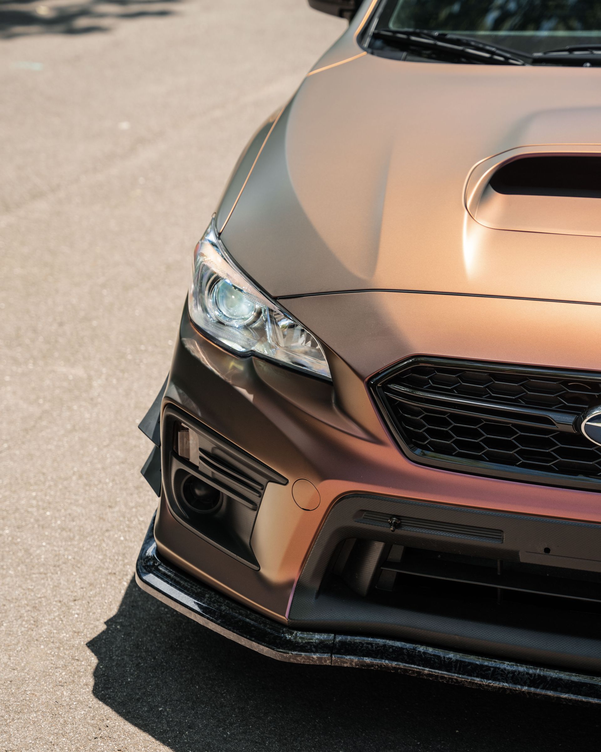 A subaru is parked on the side of the road