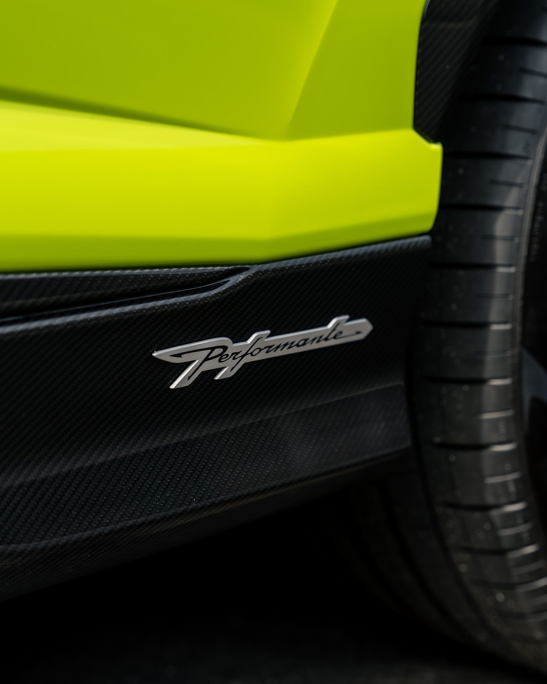 A close up of the side of a yellow lamborghini
