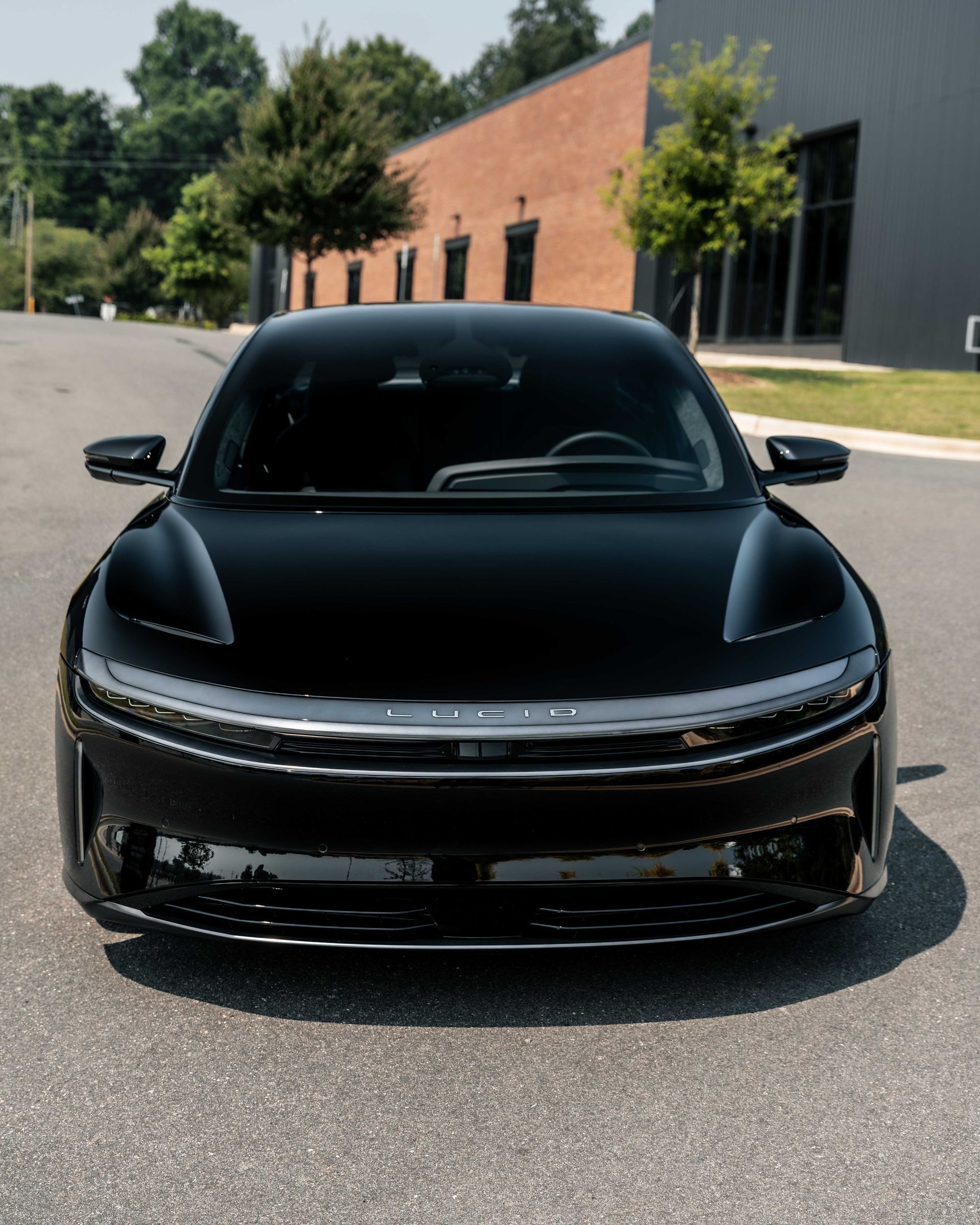 A black car is parked in front of a building