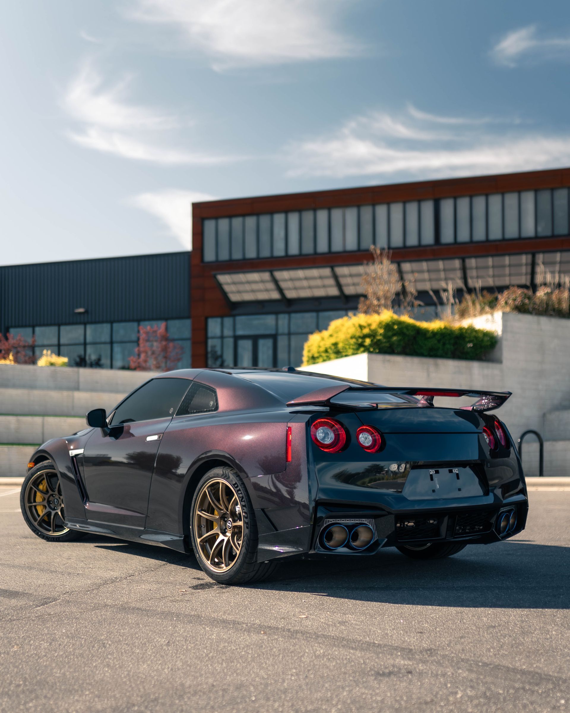 A black sports car is parked in front of a building