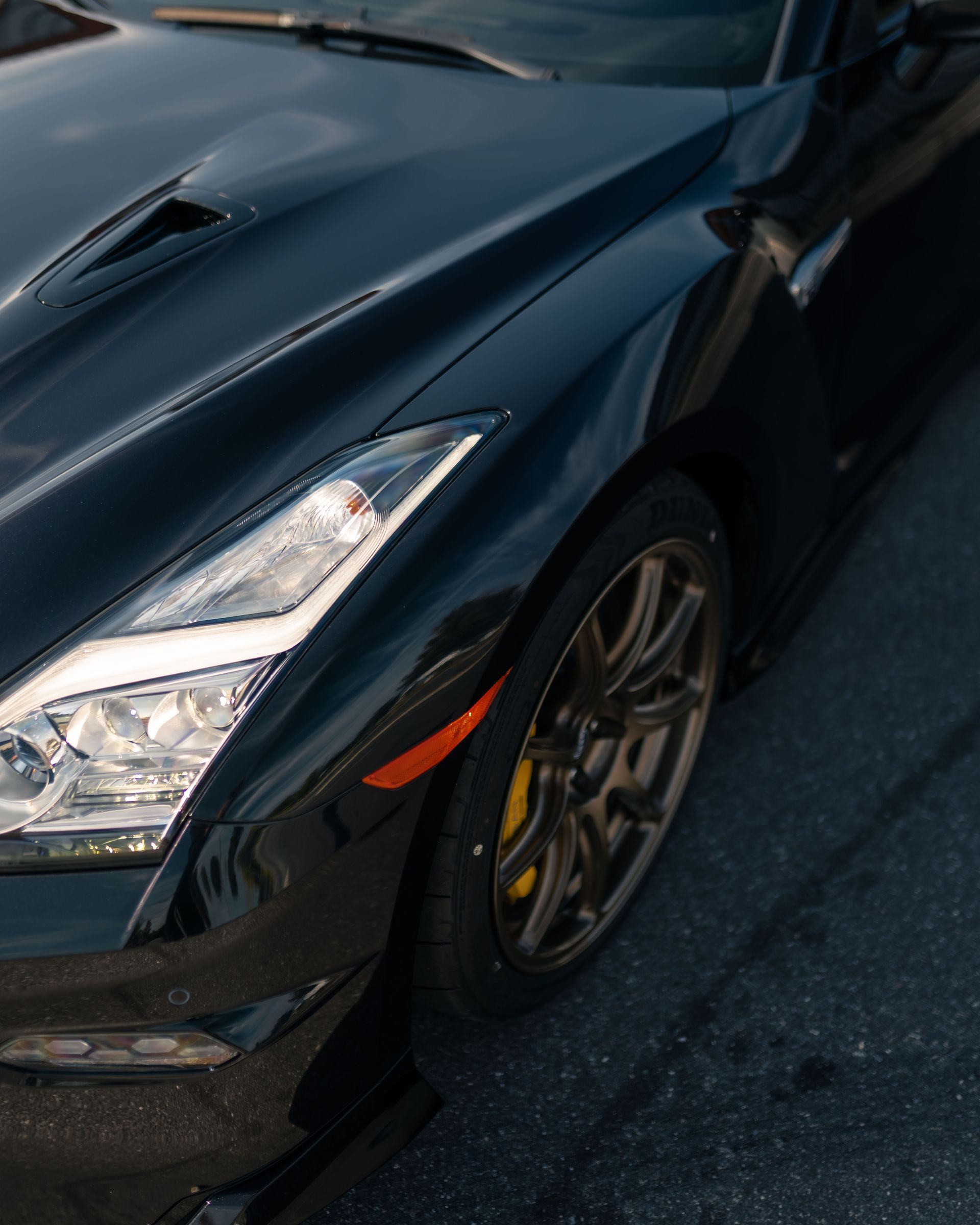 A black car is parked on the side of the road