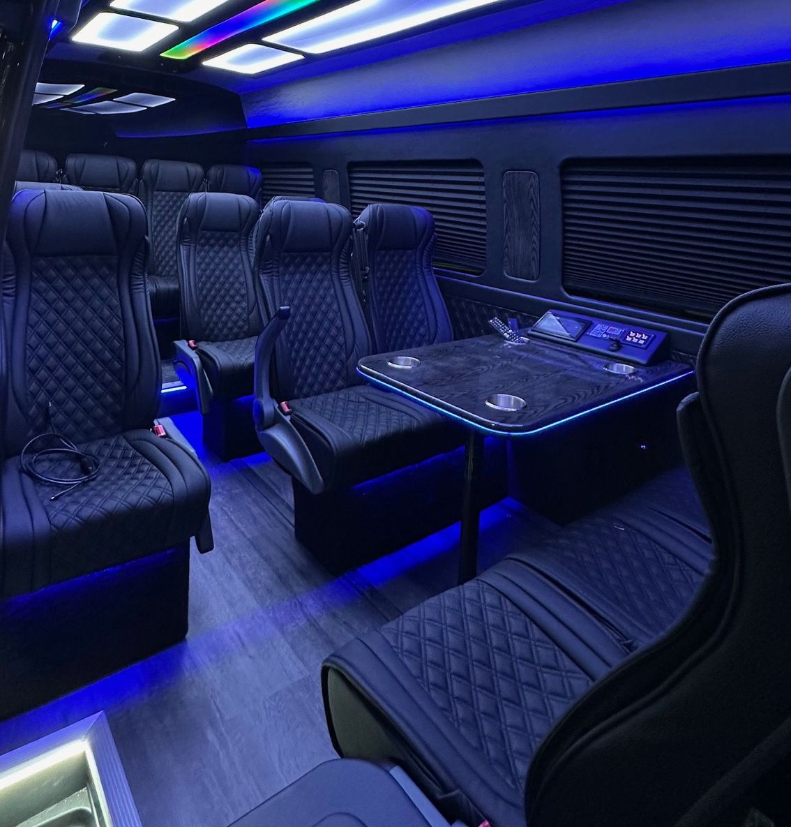 The inside of a van with a table and chairs.