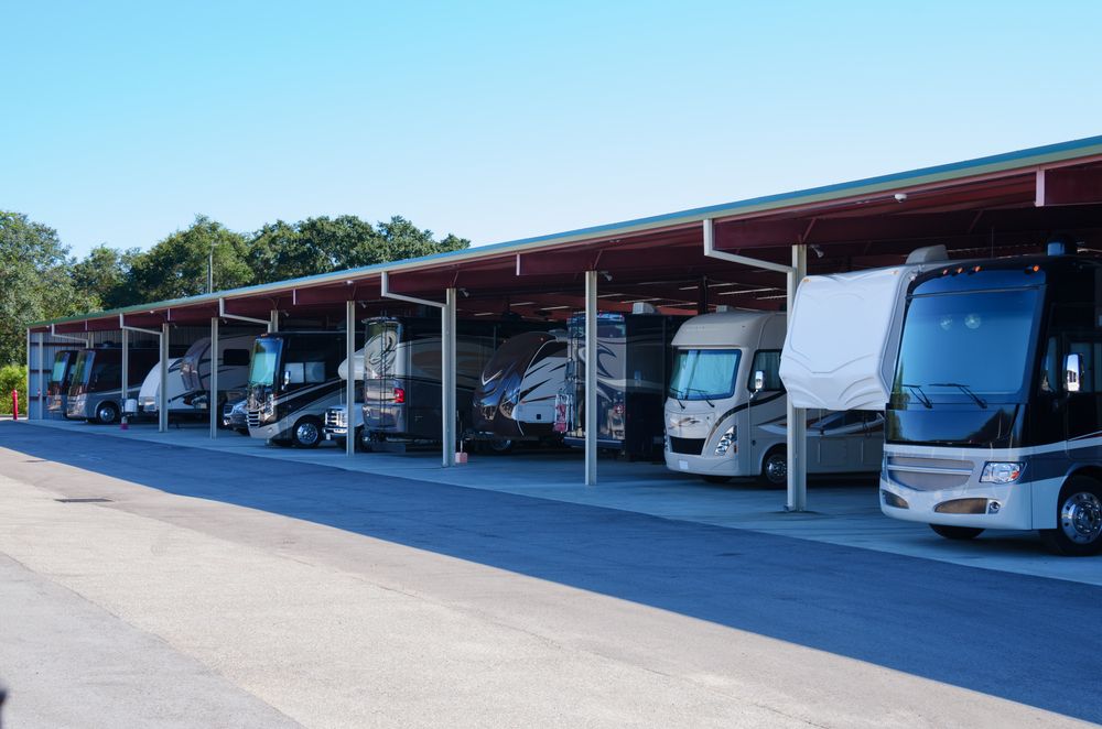 RVs and campers at an outdoor storage facility.