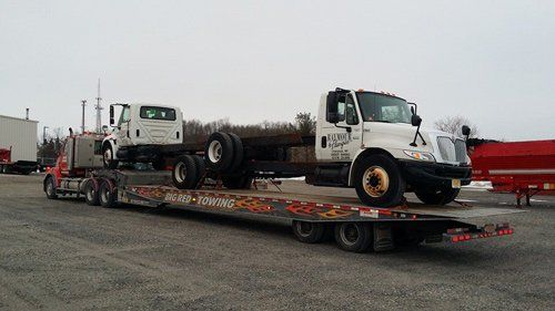 Big Red Towing with two trucks on bed - Heavy Duty Towing in Syracuse, NY
