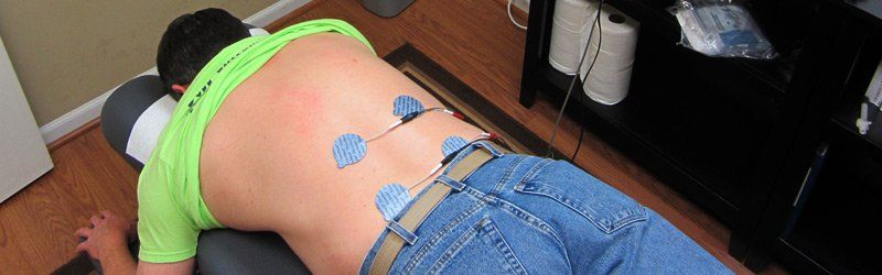 Image of a patient being treated with electrical muscle stimulation