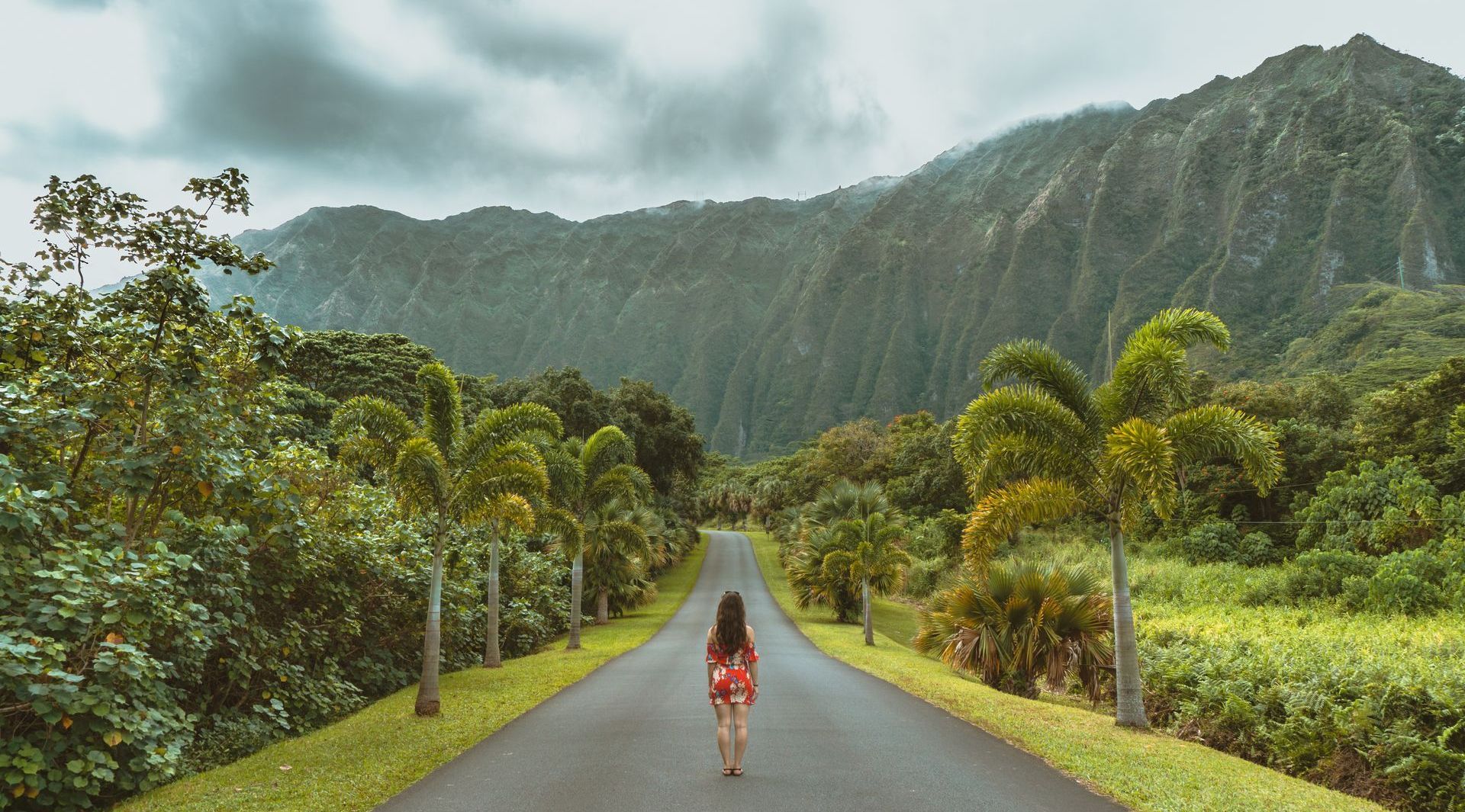 woman walking down hawaiian road