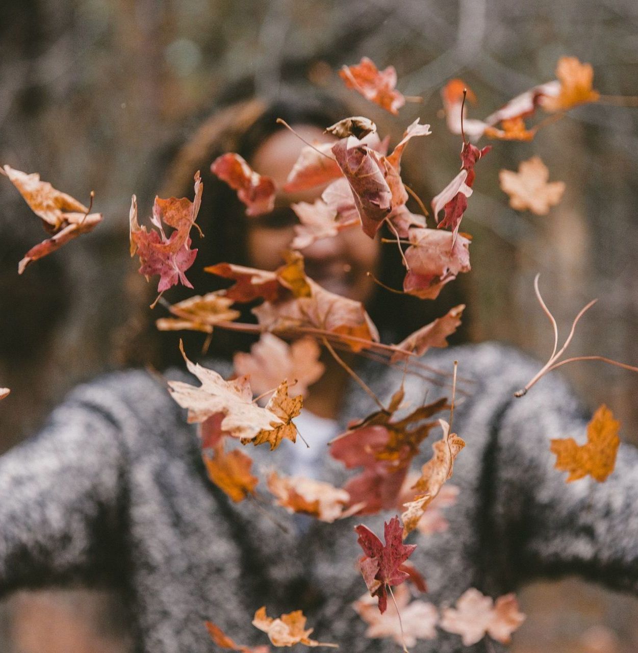 woman playing in the leaves