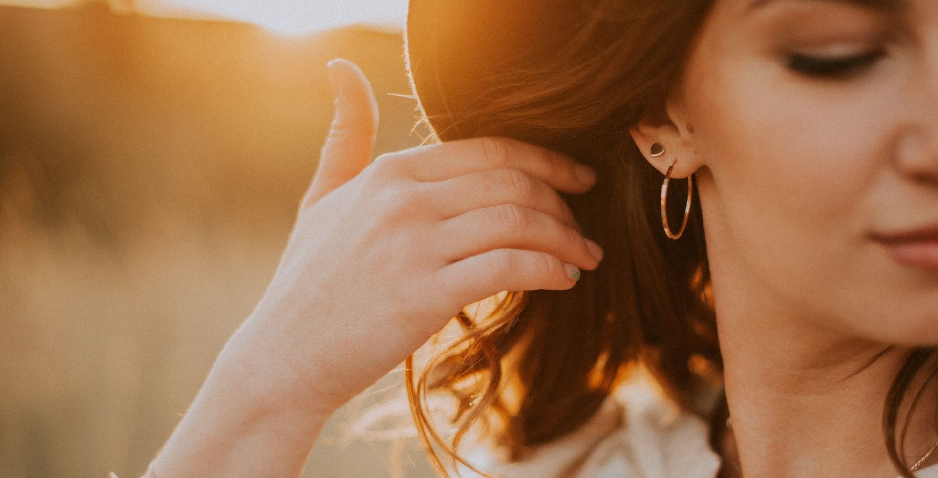 woman wearing gold earrings
