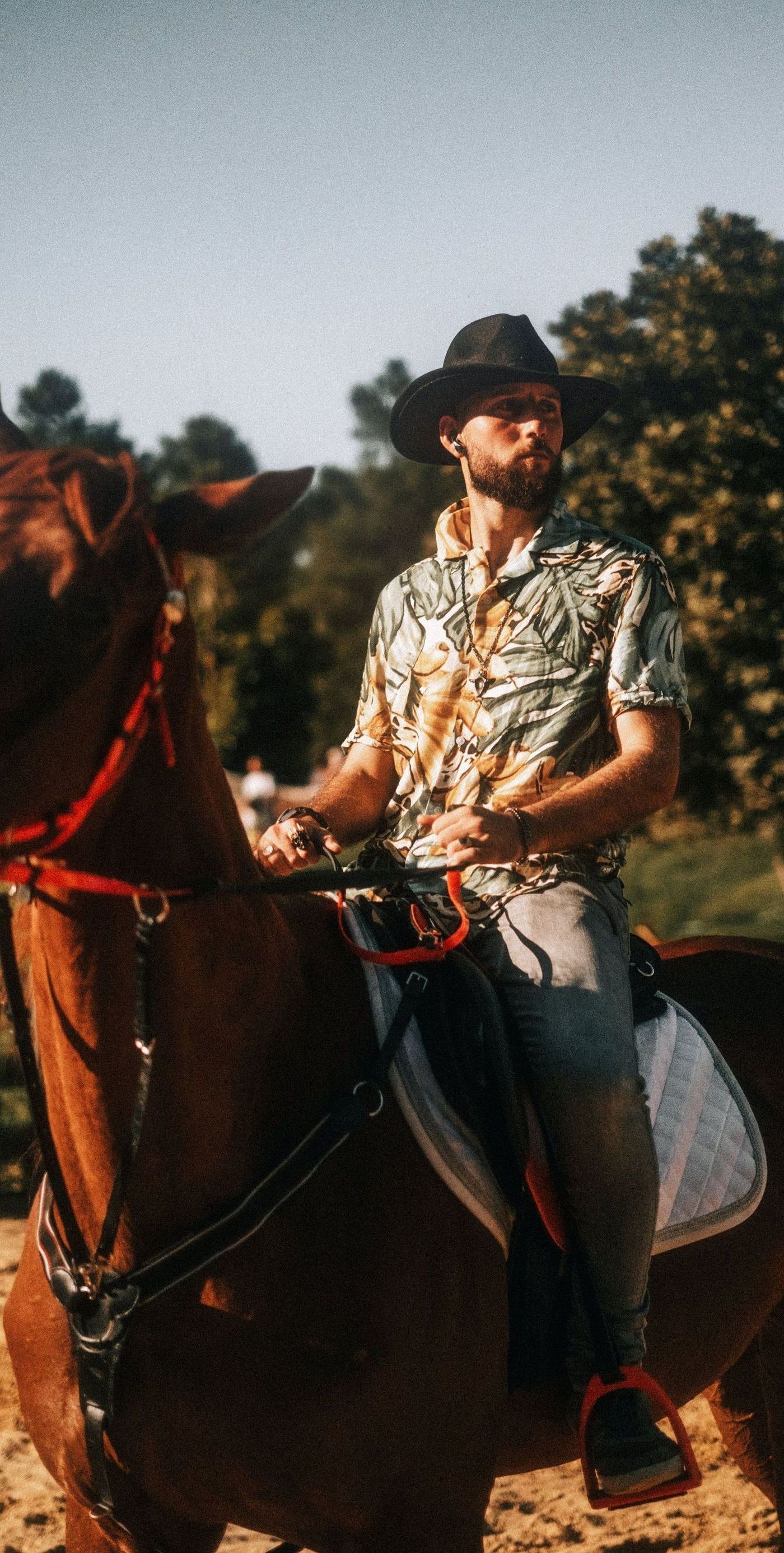 man on horse in hawaiian shirt