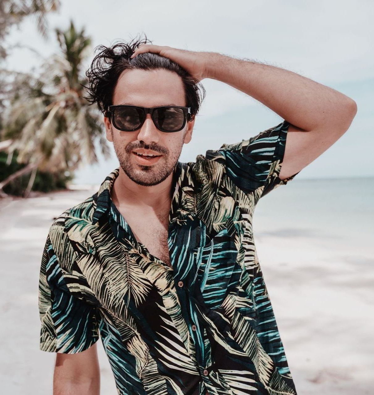 man in hawaiian shirt on beach