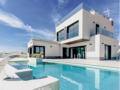 Modern two-story white villa with glass railings, large windows, and an outdoor swimming pool against a bright blue sky.