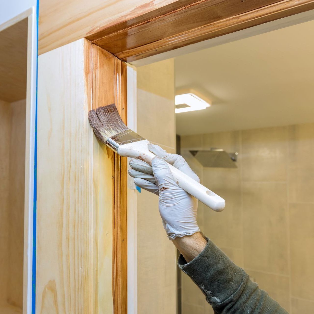 A man is painting the door