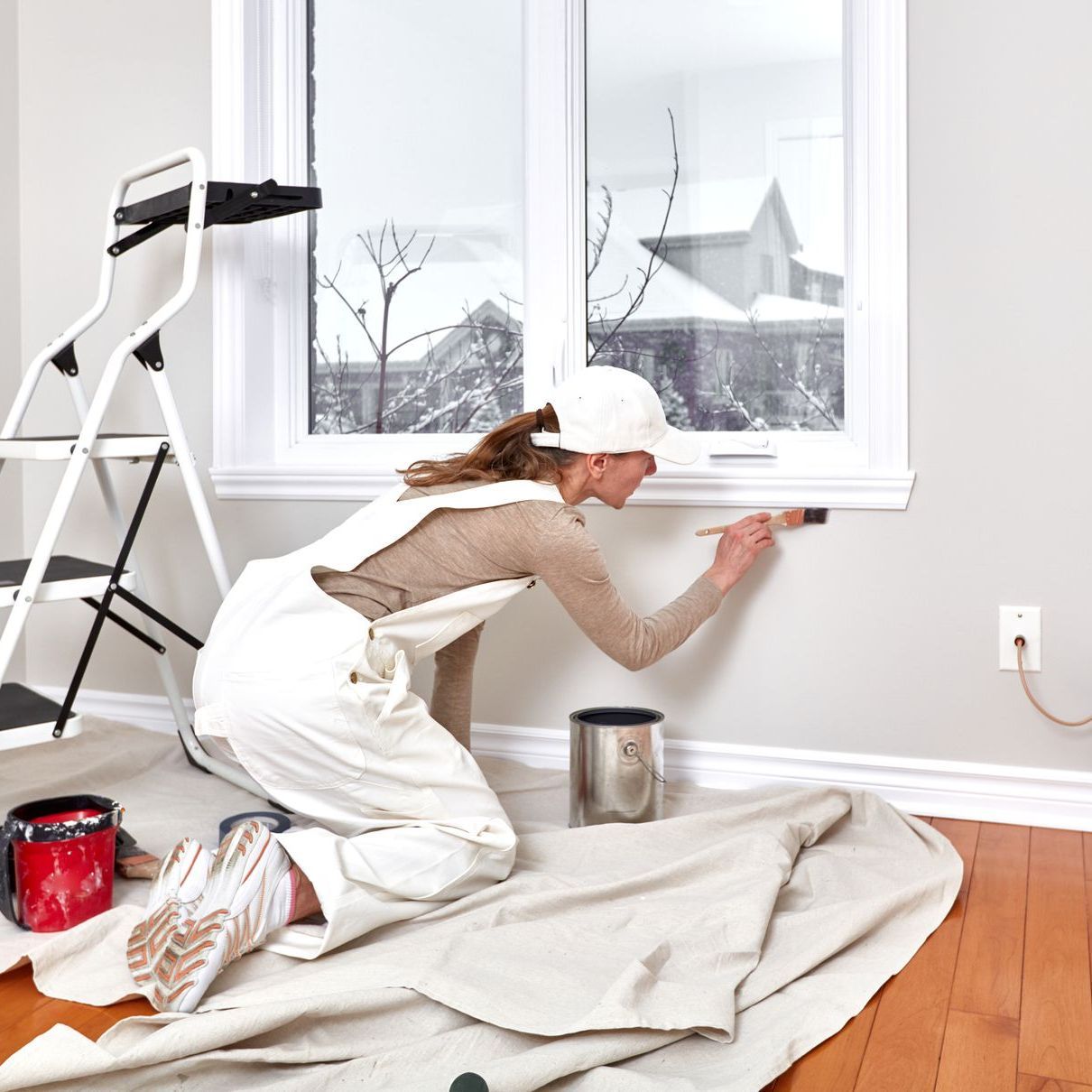 A woman is painting the window