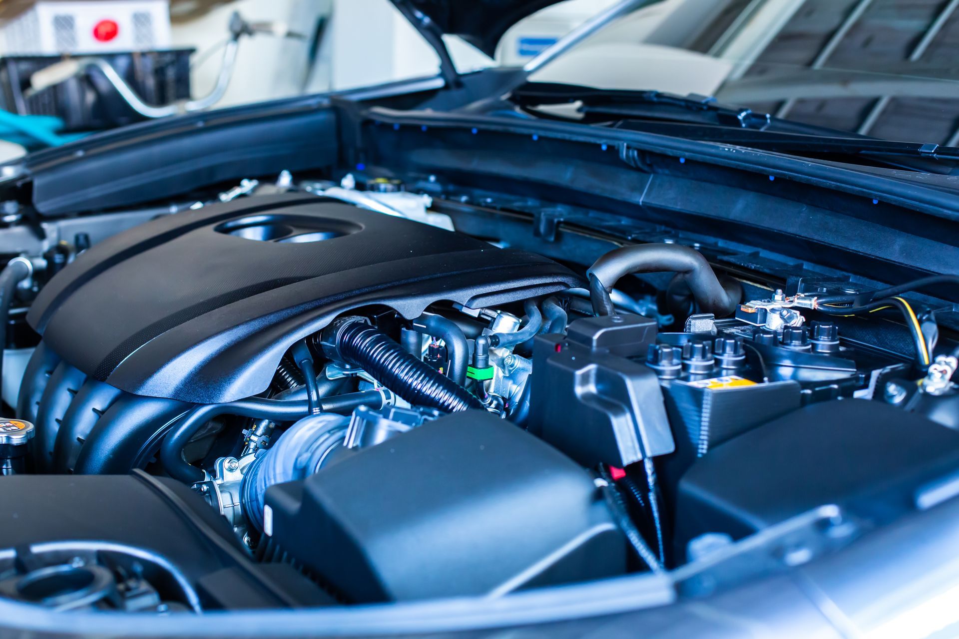 The engine of a car is shown with the hood open.