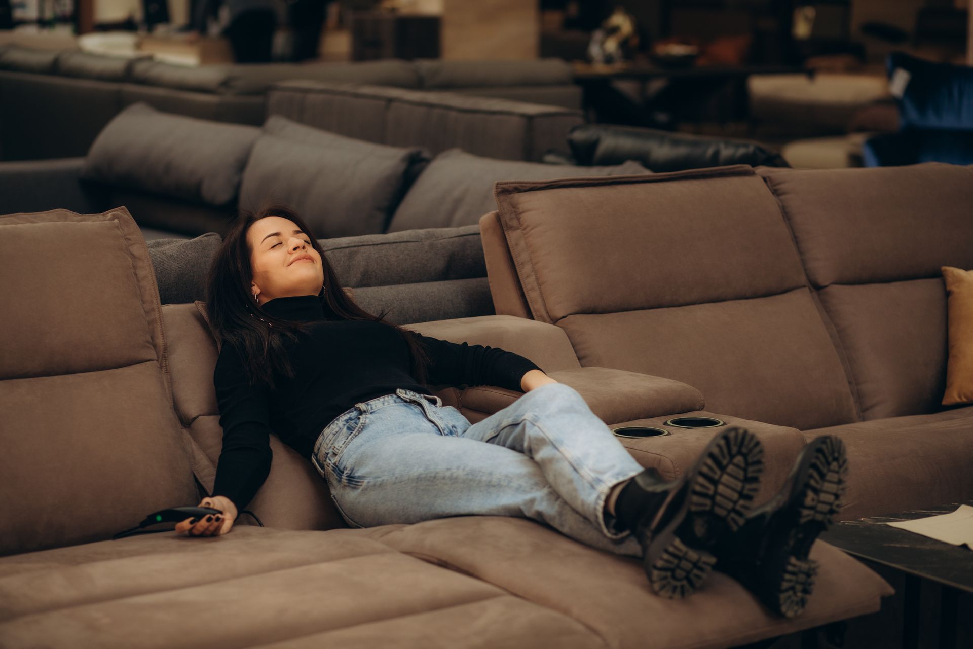 A woman is sitting on an electric recliner. A woman is sitting on an electric recliner.