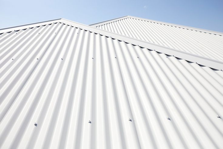 White corrugated metal roof viewed from below against a blue sky — Hinch Plumbing In Breakwater, VIC