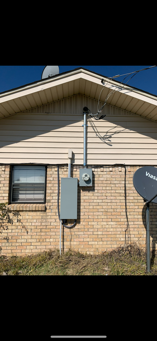 A house with a satellite dish on the side of it.