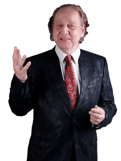 A smiling person in a dark suit and red patterned tie gesturing with their right hand against a white background.