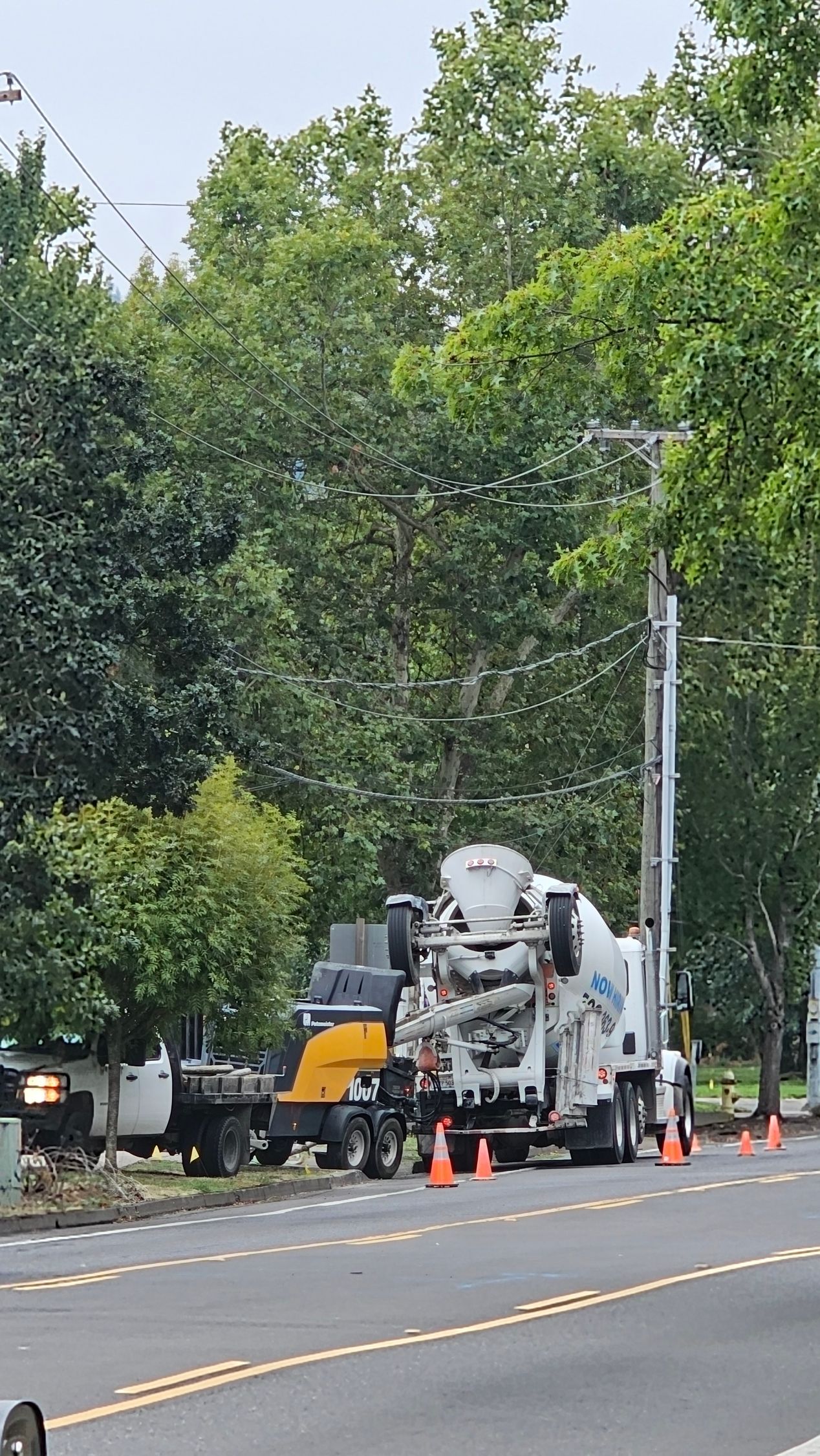 Concrete pumping with mixer and trailer pump setup on residential sidewalk project
