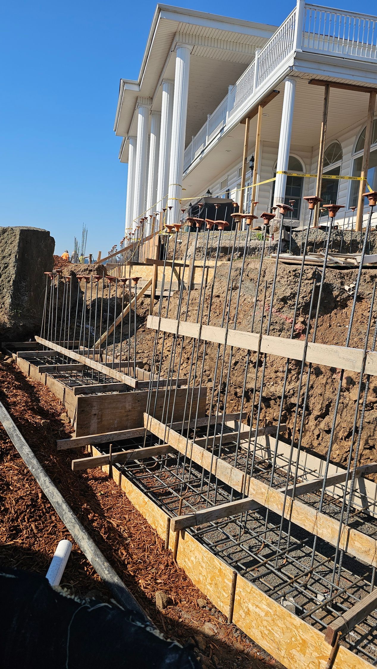 Foundation installation in progress with rebar cages and formwork for footing pours