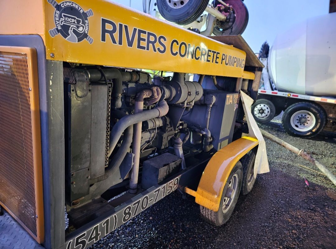 Rivers Concrete Pumping trailer pump setup beside cement truck at jobsite