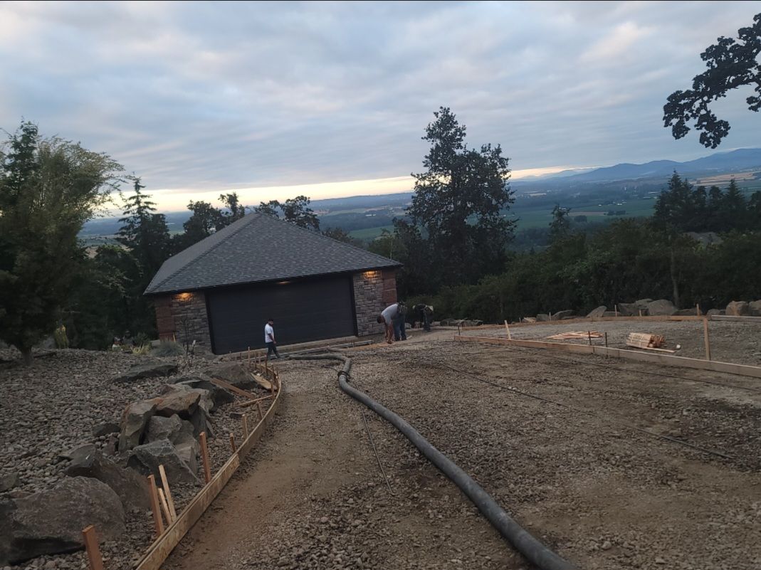 Concrete driveway grading and hose setup for residential concrete pumping